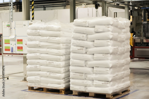 white bags evenly and neatly folded onto a pallet stand in a warehouse