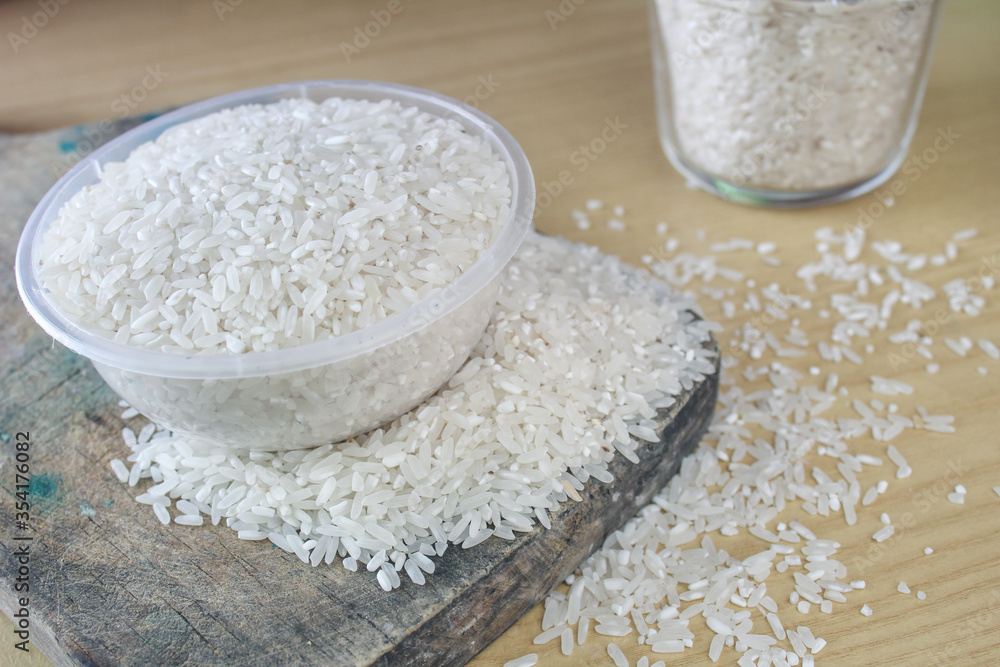Raw white rice on the table, wood background