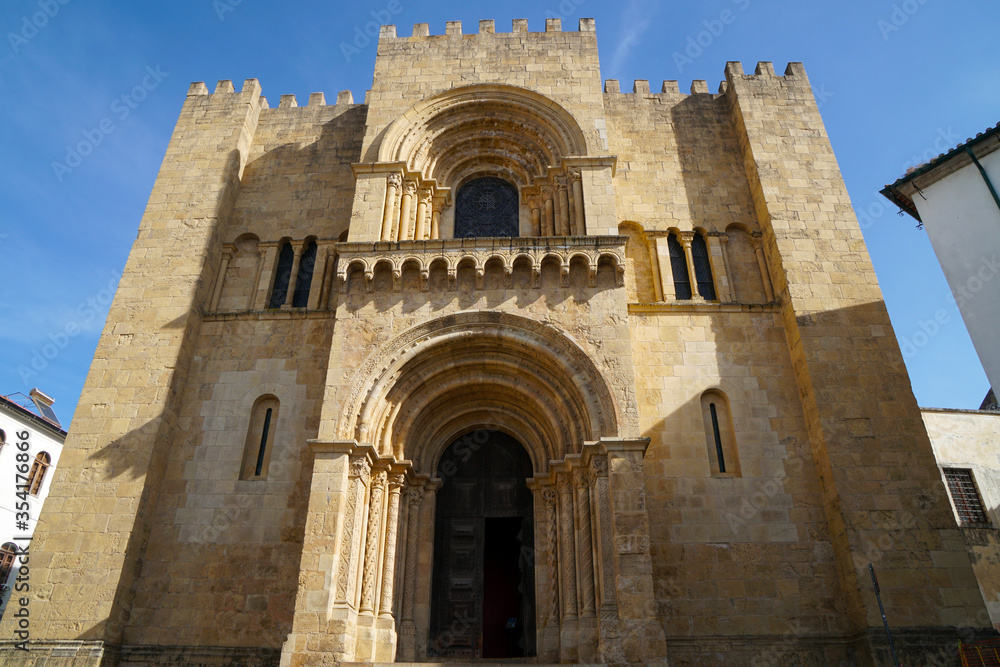 west facade of old romanesque cathedral in Coimbra
