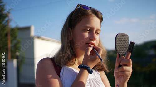 Принти на полотні Young woman draw lips with red pencil.