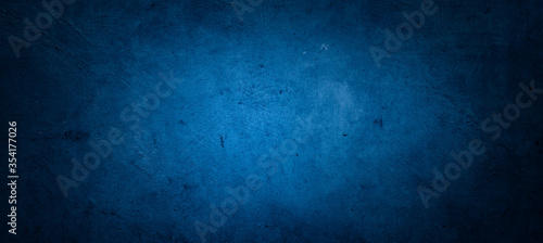 Blue textured concrete wall background. Dark edges