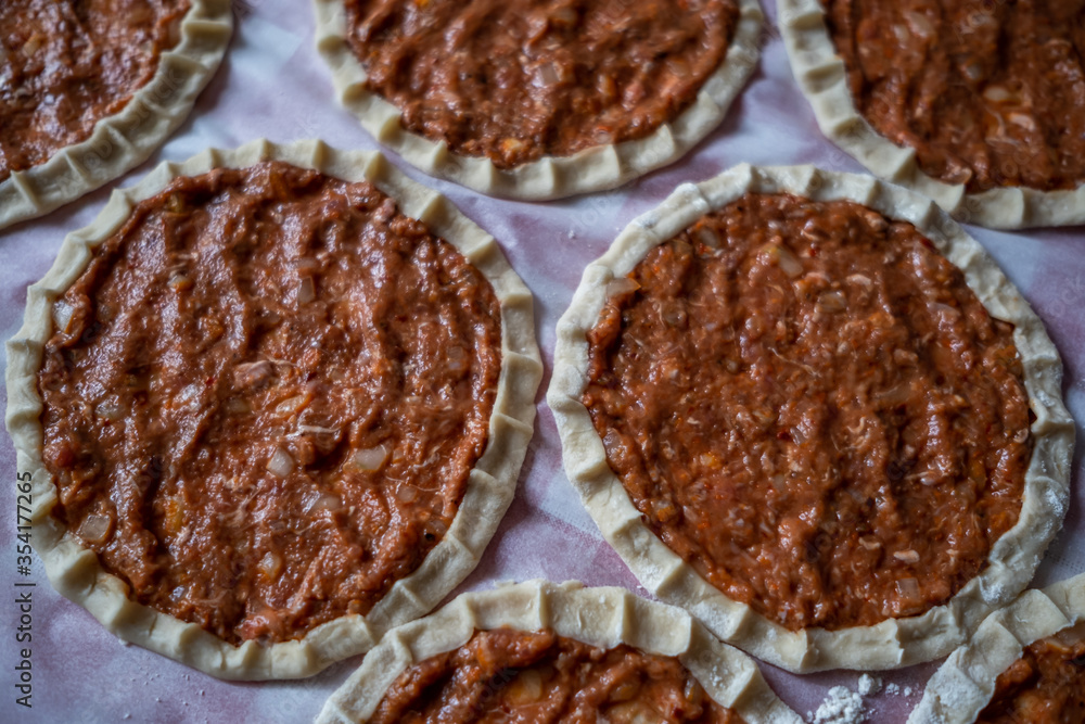 Top view of homemade pide, turkish flatbread with ground meat, mini pita breads or mini turkish pizzas Top view of homemade pide, turkish flatbread with ground meat, mini pita breads or mini turkish pizzas