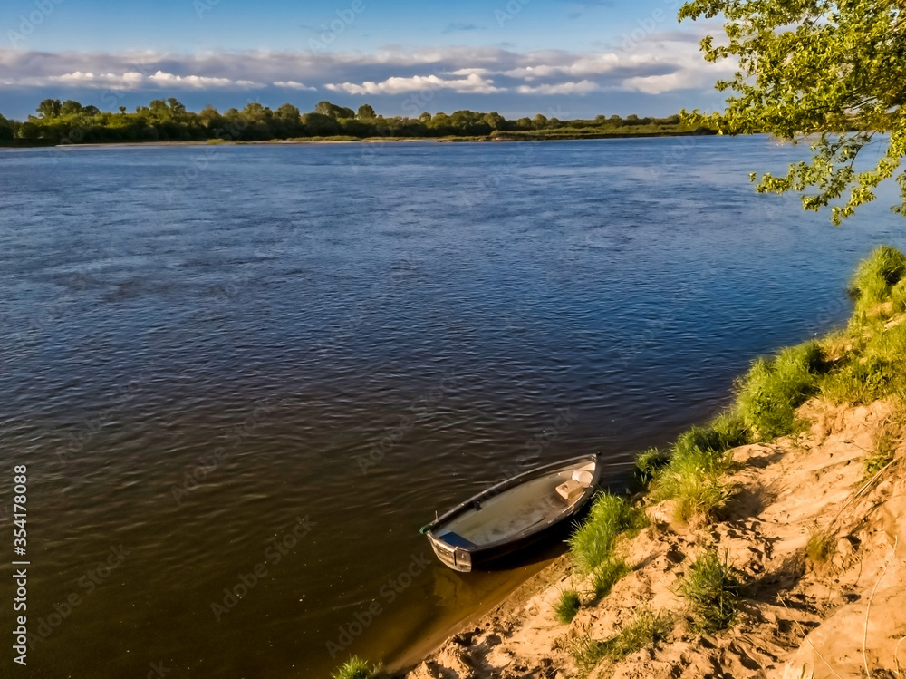 Fishing boat moored by the Vistula riverbank, vicinity of Warsaw, Poland