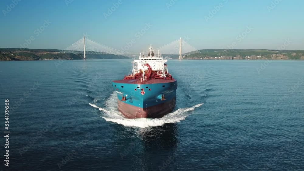 Bow and front deck of oil chemical tanker on ride. Low level track over tanker ship. Shot develops from open sea revealing ship bridge to wake water. Aerial close up of the bulbous bow breaking waves
Bow and front deck of oil chemical tanker on ride. Low level track over tanker ship. Shot develops from open sea revealing ship bridge to wake water. Aerial close up of the bulbous bow breaking waves