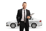Silver car and a man in a black suit posing