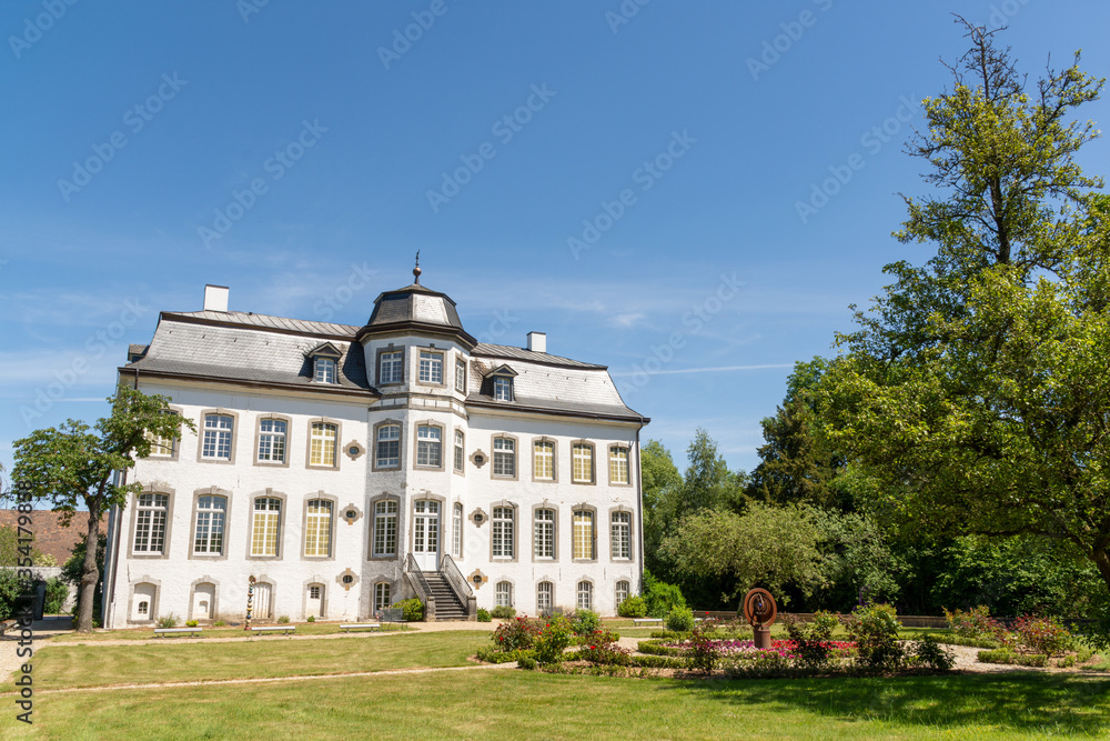 Übach-Palenberg, Germany - May 31, 2020: Zweibrüggen Castle and garden