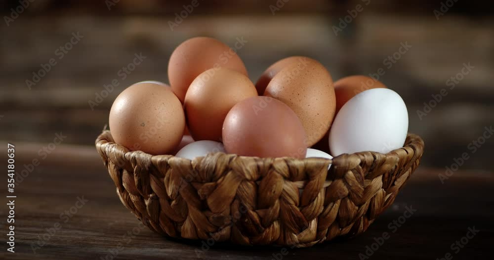 Basket with fresh raw eggs slowly rotates. Basket with fresh raw eggs slowly rotates.