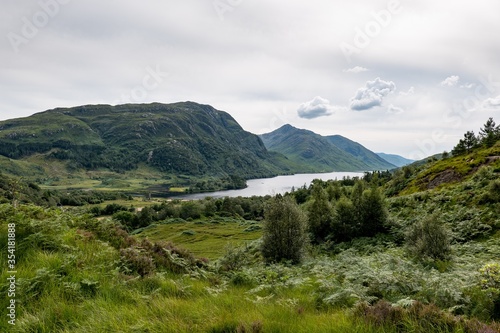 Landscape of Scottish nature, green hills, Loch Shiel lake near Glenfinnan lookout in Scotland, United Kingdom