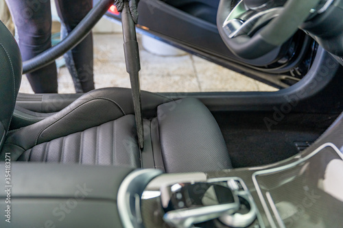 vacuuming the interior of a luxury car in the garage © edojob