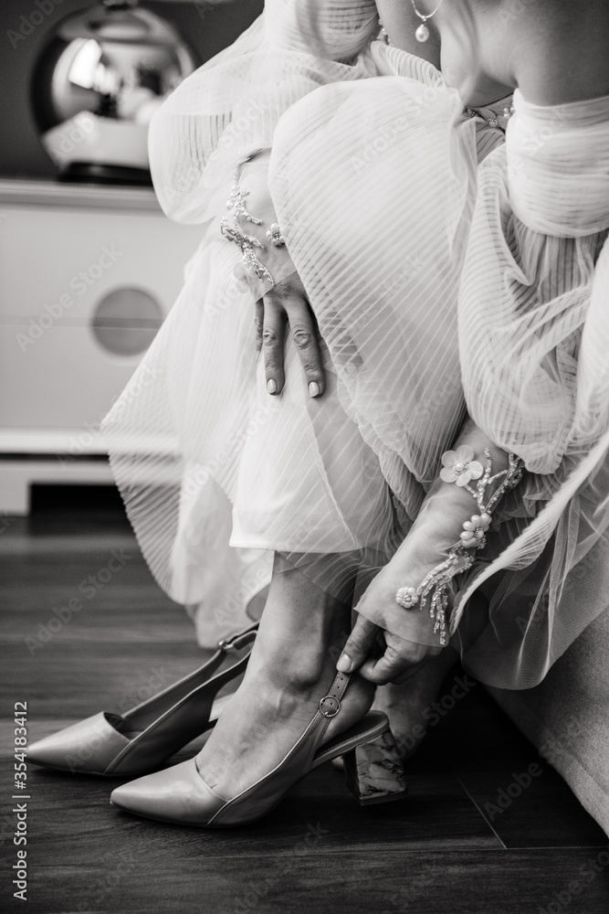 Fototapeta bride and groom in wedding dress. shoes of the bride. morning of the bride. wedding, bride, woman, dress, couple, hands, love, white, groom, hand, marriage, legs, people, beautiful, romance, beauty