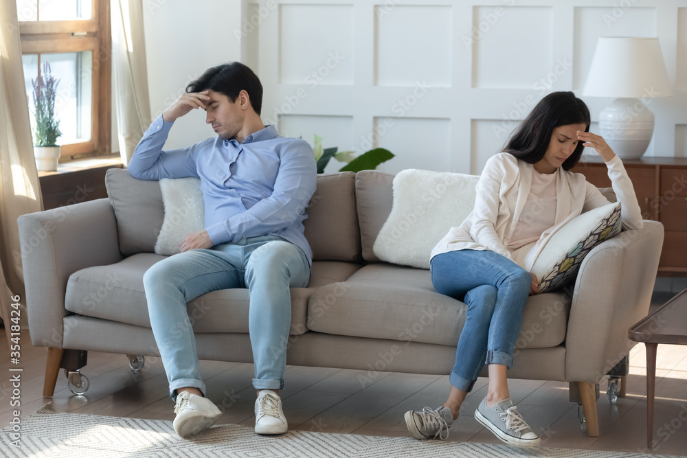 Unhappy young caucasian couple sit on sofa at home back to back think of breakup or divorce, upset millennial man and woman have family fight disagreement, struggle with relationships problems Unhappy young caucasian couple sit on sofa at home back to back think of breakup or divorce, upset millennial man and woman have family fight disagreement, struggle with relationships problems