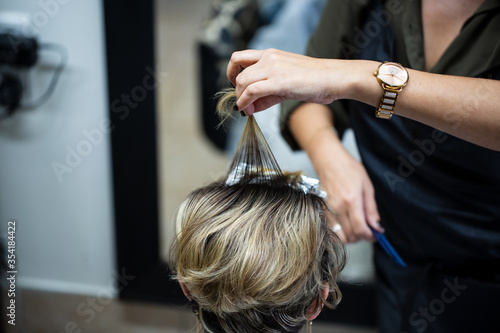 hairdresser cutting hair of a woman