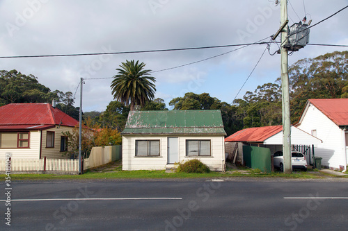 Fototapeta Naklejka Na Ścianę i Meble -  A typical detached double fronted bungalow home with a corrugated roof and clapboard walls in Strahan - Tasmania.
