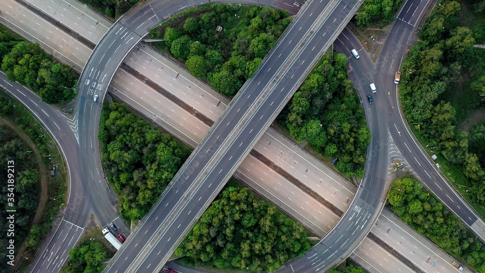 wide angle aerial view of motorway junction day and night