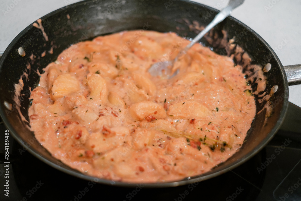 People making meat sauce together. Frying pan with sauce on an induction stove. Concept of home cooking healthy food. People making meat sauce together. Frying pan with sauce on an induction stove. Concept of home cooking healthy food.