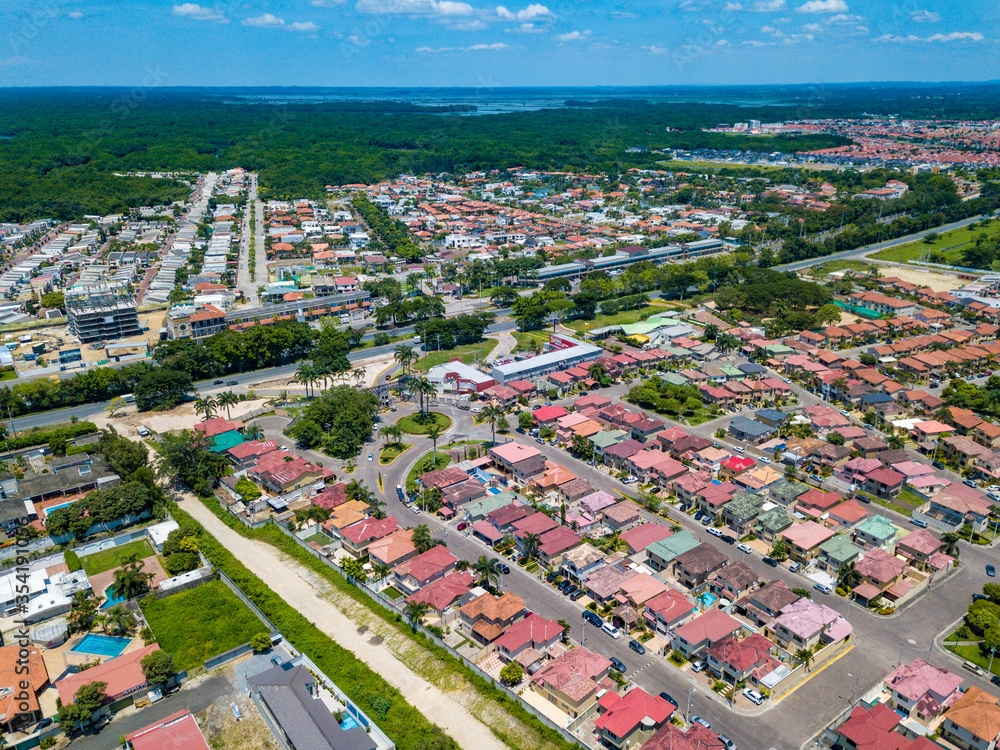 Aerial drone view of gated communities outside Guayaquil City, Ecuador and the main highway going to Via a la Costa. Shot from over houses and homes.
