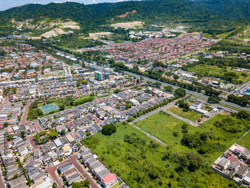 Aerial drone view of gated communities outside Guayaquil City, Ecuador and the main highway going to Via a la Costa. Shot from over houses and homes.