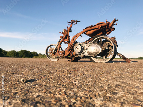 rusty scooter in an empty field