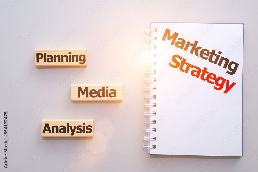 Planning marketing strategy. Top view close-up image, words written om wooden blocks Planning marketing strategy. Top view close-up image, words written om wooden blocks