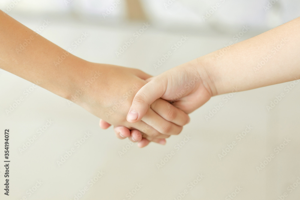 Children shaking hands, the concept of mutual assistance and friendship