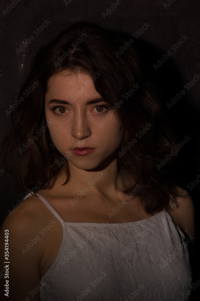 Female studio portrait in low light conditions Female studio portrait in low light conditions