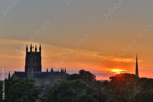A warm sunset over the city of Worcester with a view of the cathedral and its tower. Worcestershire, England, UK.  photo