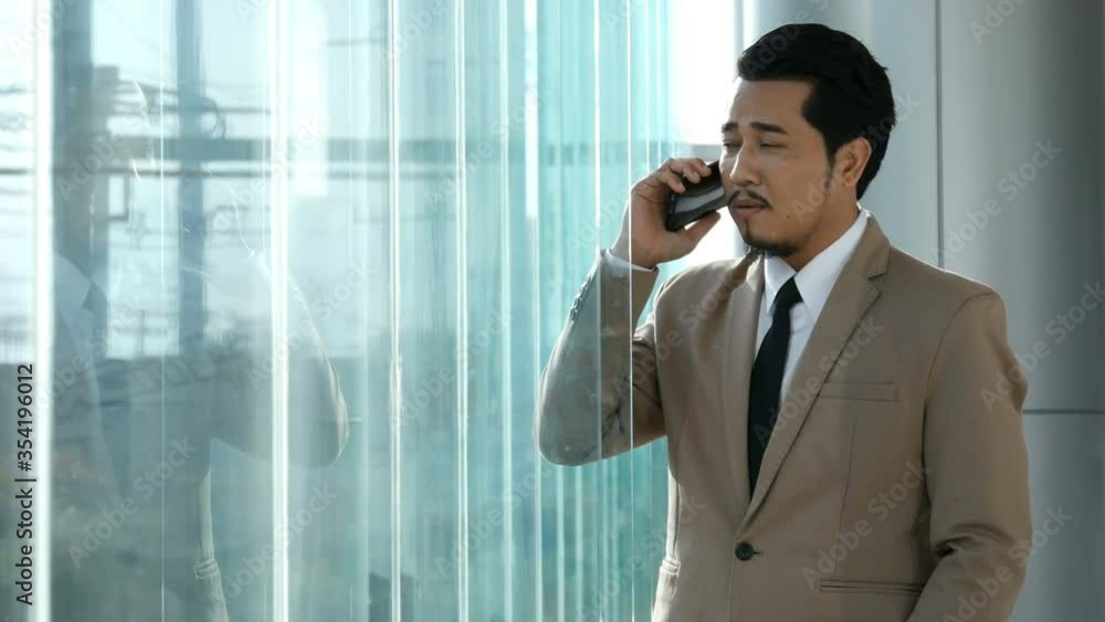 young business man talking with mobile phone in office. 4k video young business man talking with mobile phone in office. 4k video