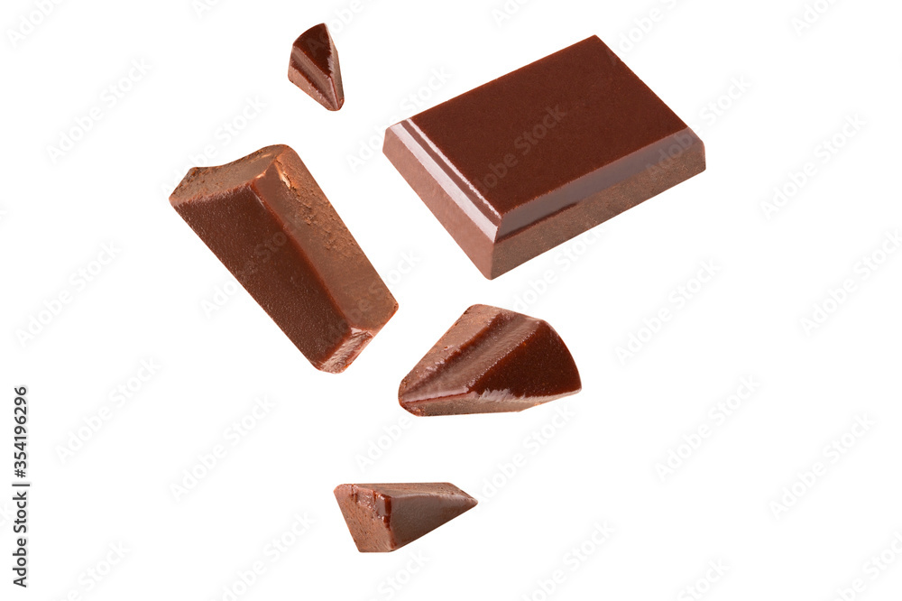 Three dark chocolate pieces Blast pieces in the air on a white background .Clipping path Three dark chocolate pieces Blast pieces in the air on a white background .Clipping path
