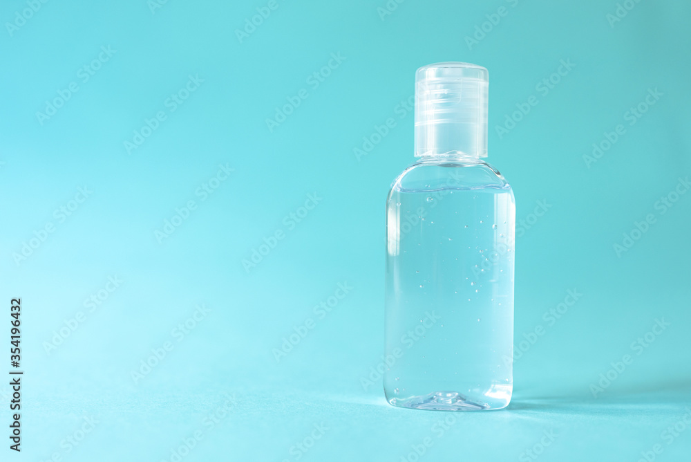 Transparent alcohol bottle is a device to prevent and stop the corona virus. on blue isolated backgroun