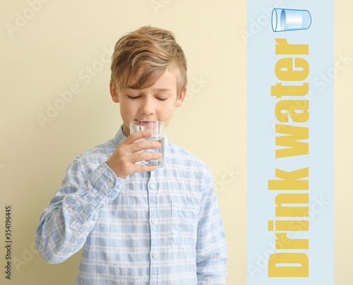 Cute little boy drinking wa...