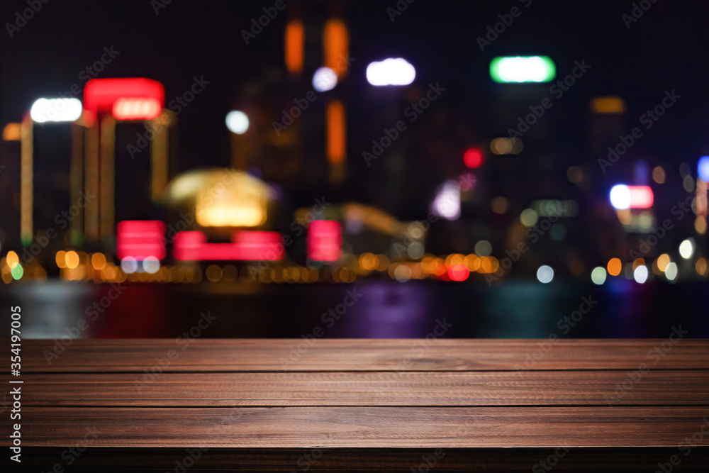 Empty wooden table space platform and blurred night city or dining background for product display montage