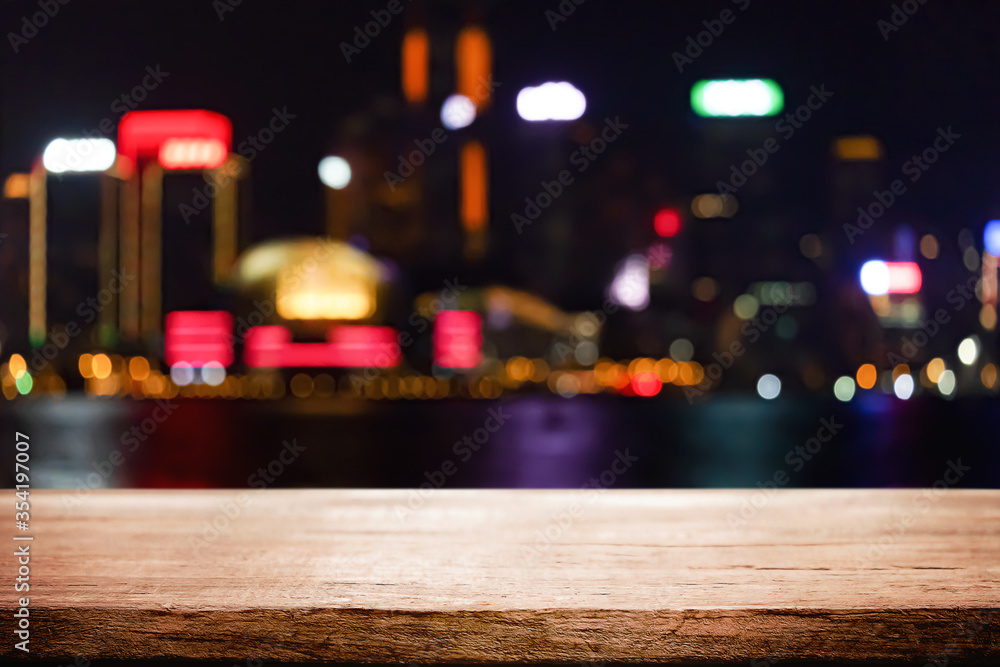 Empty wooden table space platform and blurred night city or dining background for product display montage