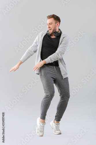 Handsome dancing man on grey background