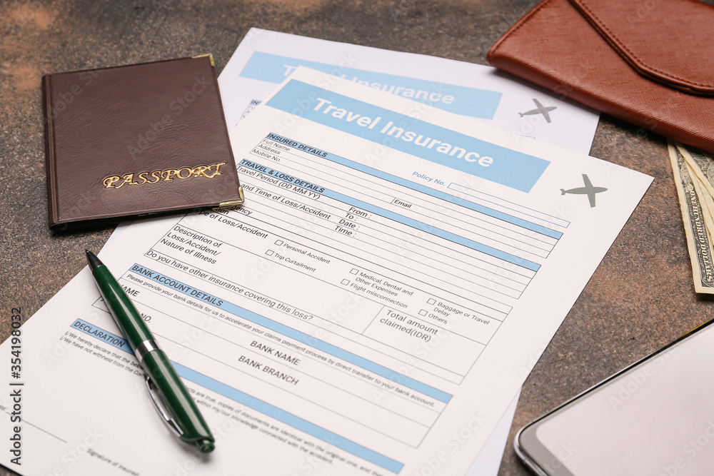 Travel insurance forms with passport and money on grey background Travel insurance forms with passport and money on grey background
