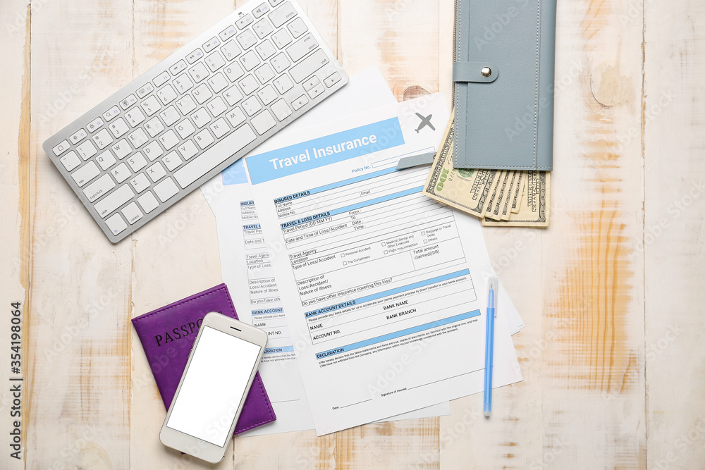 Fototapeta premium Travel insurance application and vacation planning, financial protection for international trips with passport and currency on a wooden desk surface