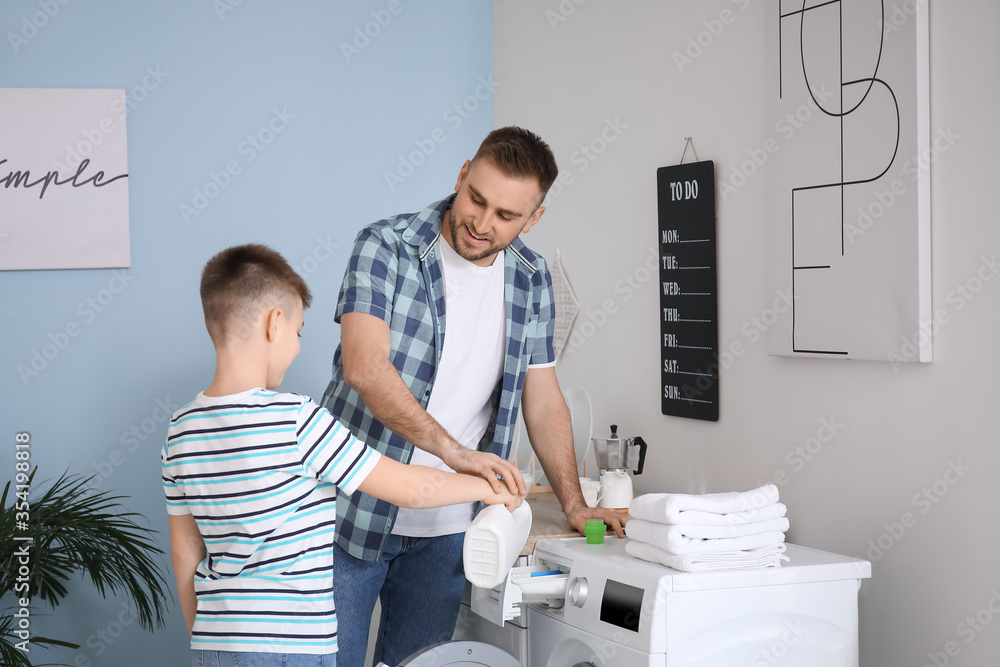 Man and his little son doing laundry at home Man and his little son doing laundry at home