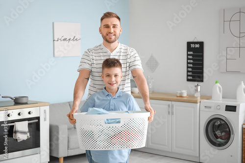 Father and son carrying a l...