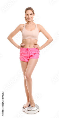 Young woman measuring her w...