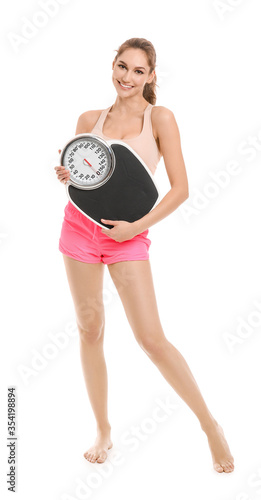 Young woman with weight sca...