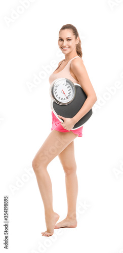 Young woman with weight sca...