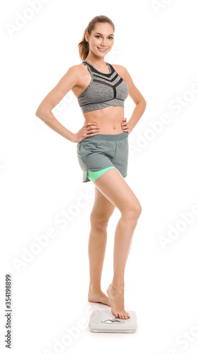 Young woman measuring her w...