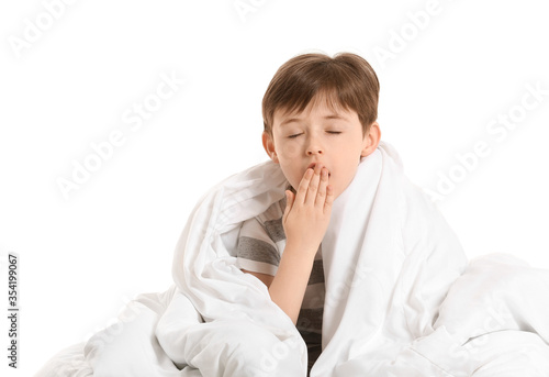 Yawning little boy wrapped ...