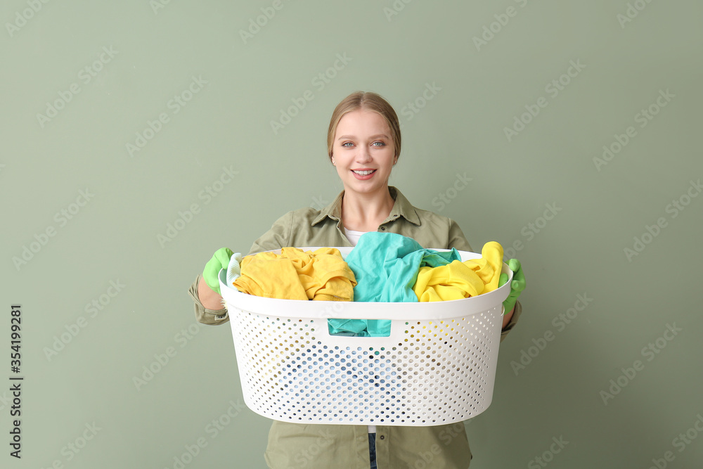 Young woman with laundry on color background Young woman with laundry on color background