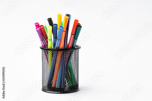 Color pen in black metal container on white background photo