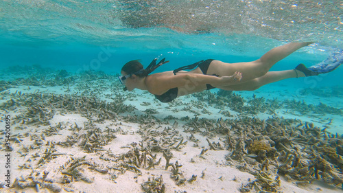UNDERWATER: Woman on vacation in Maldives explores the once vibrant coral reef.