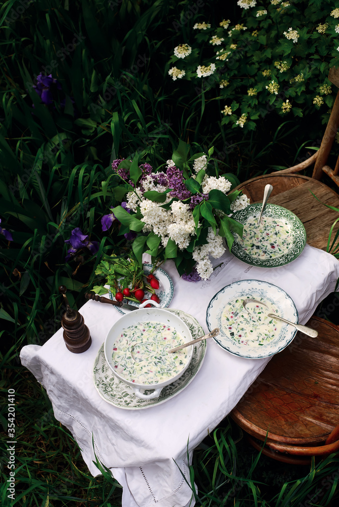 okroshka, a traditional Russian cold soup on a table set okroshka, a traditional Russian cold soup on a table set