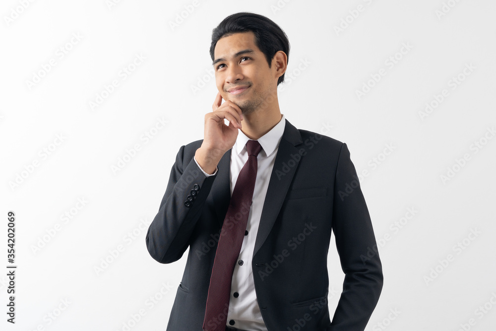 happy young asian businessman smiling and thinking in formal suit isolated on white background. happy young asian businessman smiling and thinking in formal suit isolated on white background.