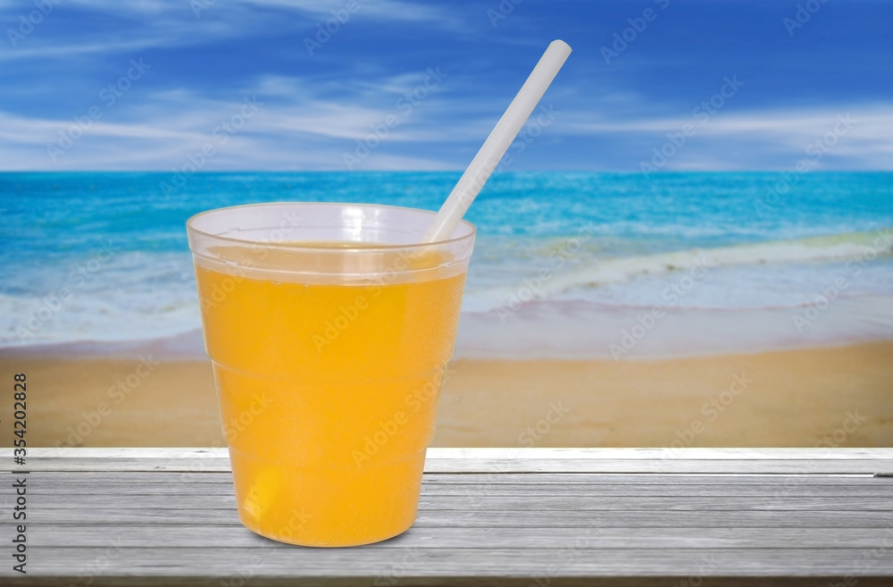 glass of orange juice on the beach glass of orange juice on the beach