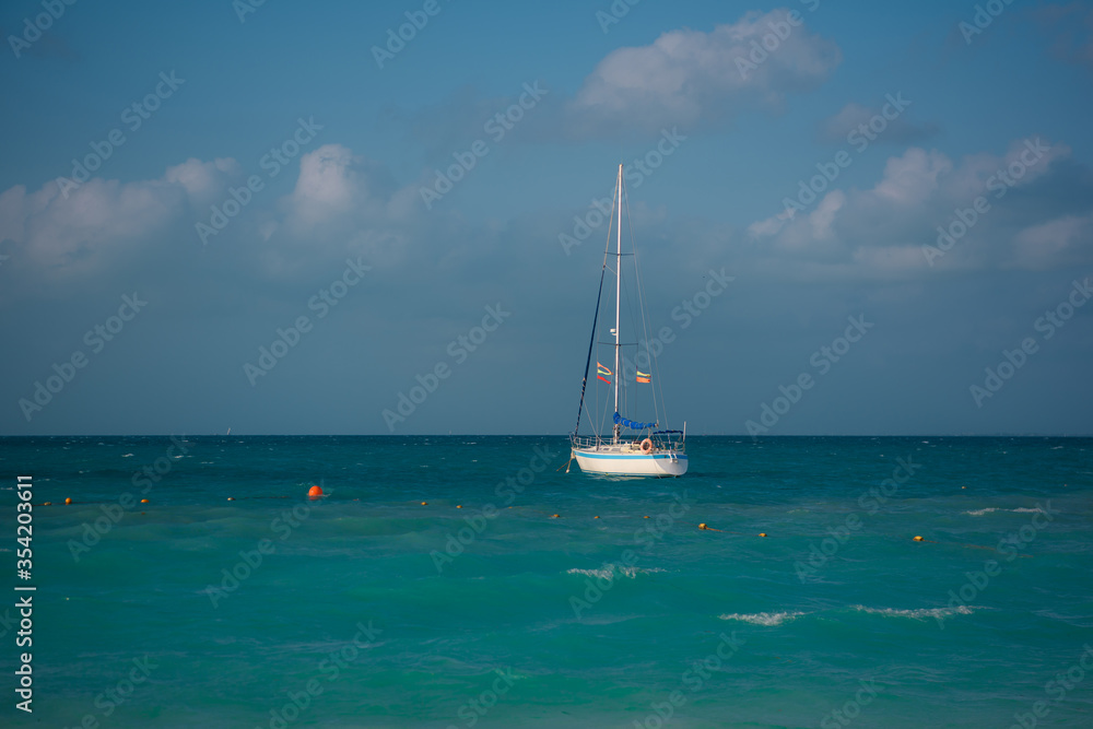 Sailing boat with lowered sails on the sea. Mexico. Sailing boat with lowered sails on the sea. Mexico.