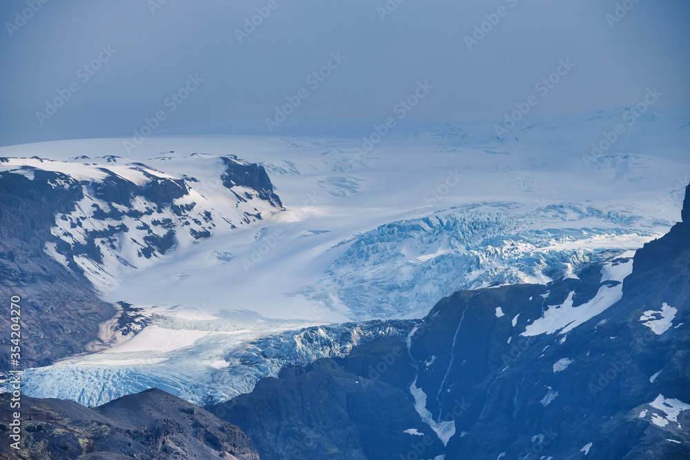 Beautiful blue iced glaciers retreating back into the mountains on the south east of Iceland Beautiful blue iced glaciers retreating back into the mountains on the south east of Iceland